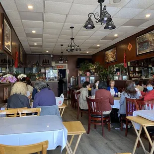 people sitting at tables in a restaurant