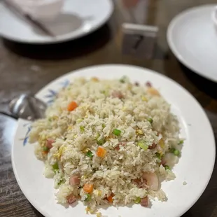 a plate of fried rice and vegetables