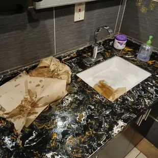 Very unsatisfied with the gross men&apos;s bathroom. 1 stall was out of order (out of 2 total), clogged sink, empty soap, and full trash.
