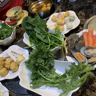 Vegetables, fried tofu, shrimps, mussels, variety of fish balls, enoki mushrooms