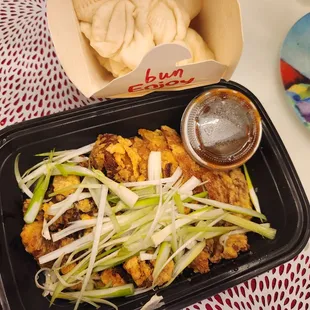 a tray of food with a side of dipping sauce