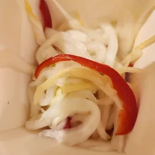 onions and peppers in a paper bag