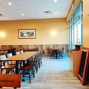 a dining area with tables and chairs