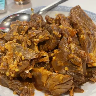 a plate of beef and corn