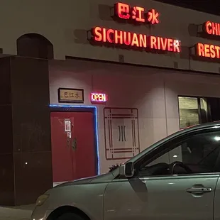 a car parked in front of a restaurant