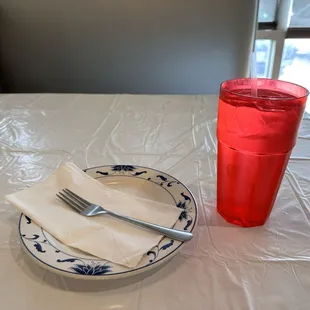 a plate with a fork and a glass of water