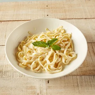 a bowl of pasta and basil