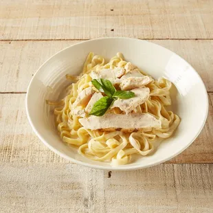 a bowl of pasta and chicken