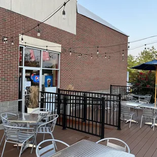 a patio with tables and chairs