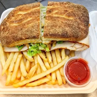 Turkey panini (side of fries), ketchup, and chips.
