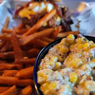 a plate of fries and a bowl of macaroni and cheese