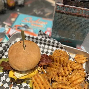 SICKIES BURGER: Peppered bacon, fried egg, pulled pork, BBQ sauce, American cheese, an onion ring, and Frank&apos;s Red Hot Sauce.
