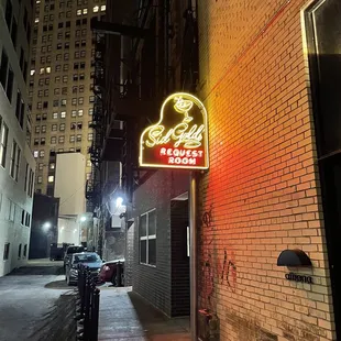 a neon sign on the side of a building