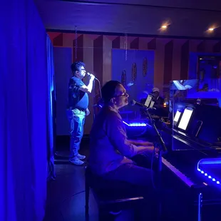 a woman playing a piano