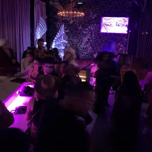 a group of people sitting at a bar