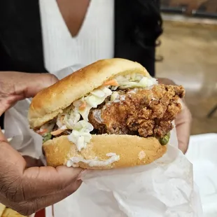 a person holding a chicken sandwich