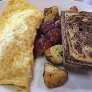 Three egg omelette with pastrami, roasted potatoes and marble rye
