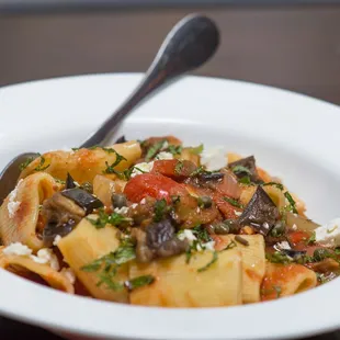 a bowl of pasta with a spoon in it