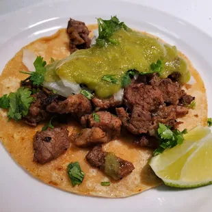 a close up of a taco on a plate
