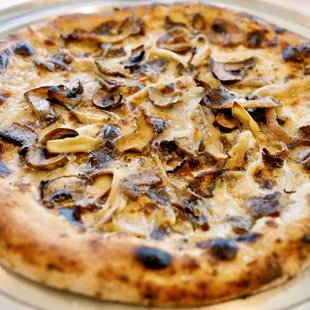 a pizza with mushrooms on it