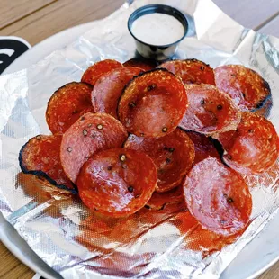 pepperoni slices on tin foil