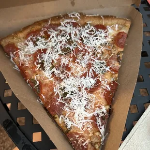 a slice of pizza in a box
