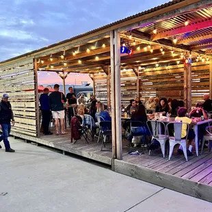 a group of people sitting at a table outside