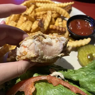 a person holding a piece of food