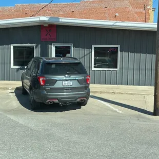 two cars parked in front of a restaurant