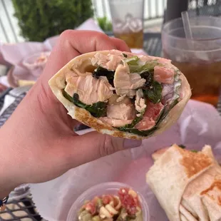 a hand holding a burrito