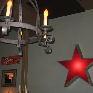 a chandelier with a red star on the wall