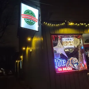 a neon sign in front of a restaurant