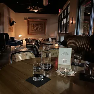 a table with a menu and glasses on it