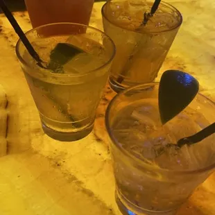 three different cocktails on a bar