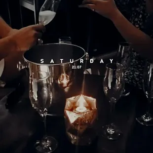 a person pouring wine into a wine glass