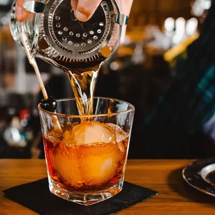 a bartender pouring a drink