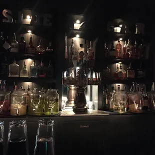 a dimly lit bar with bottles of liquor