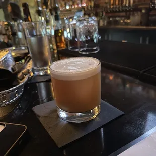a drink in a glass on a bar