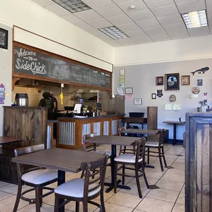 the inside of a restaurant with tables and chairs