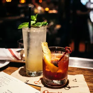 a drink and a menu on a table