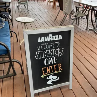 a chalkboard sign on a deck