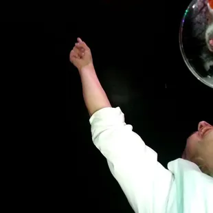 a baby reaching up to catch a fish