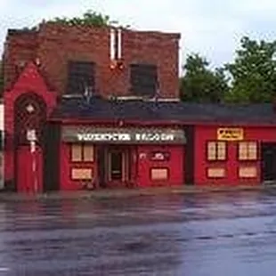 a flooded street in front of a restaurant