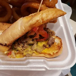 Cheesesteak comes with onions, peppers and cheese sauce. A bit salty.