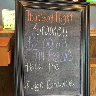 a chalkboard with a price list on it