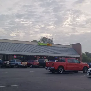 cars parked in front of a restaurant