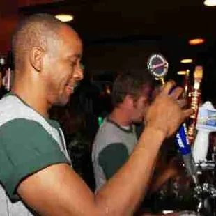 a man pouring a beer