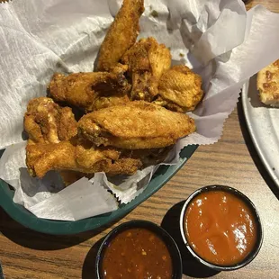 Dry rub Cajun wings with a side of mild and 3 pepper blast