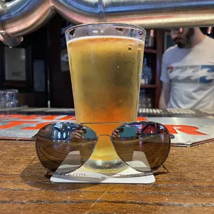 a glass of beer and sunglasses