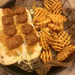 Spicy garlic shrimp po' boy with waffle fries.